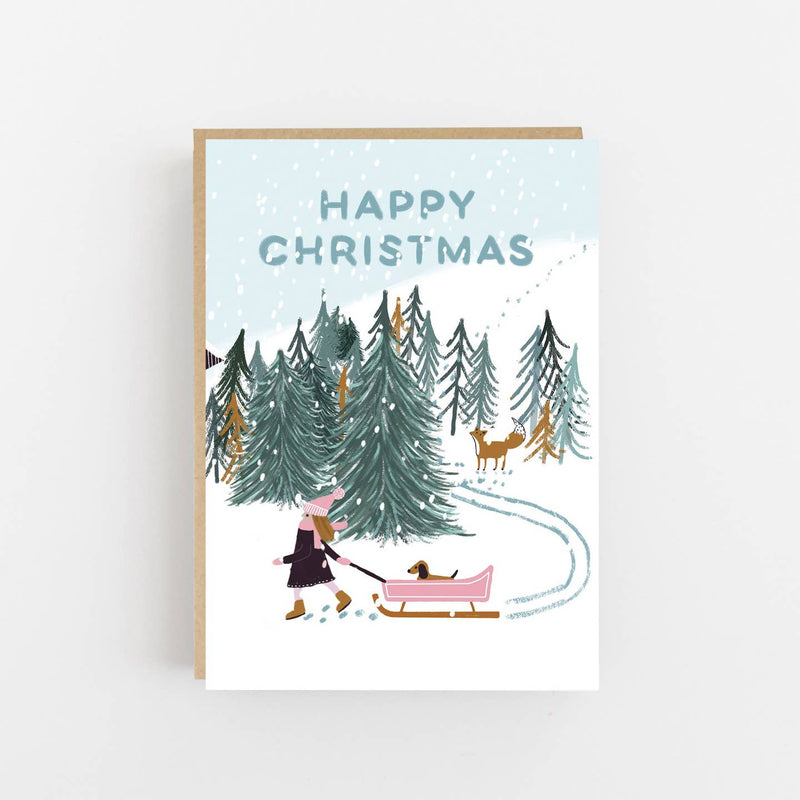 Happy Christmas girl with dog in pink sledge card