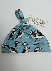 Baby knotted hat - Puffins on pale blue