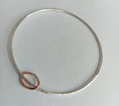 Sterling silver hammered bangle with copper runner
