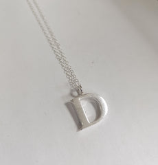 Sterling silver sand cast letter D necklace