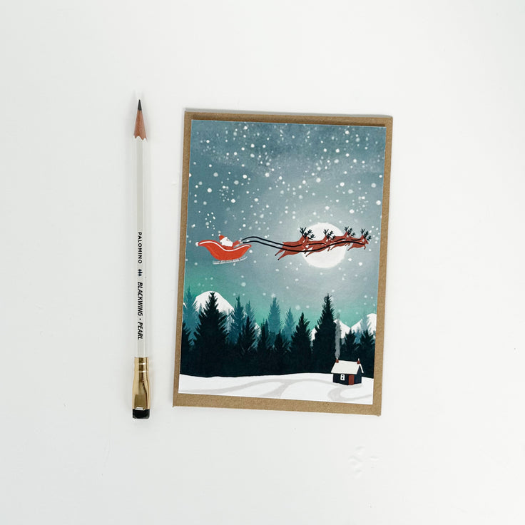 Santa with flying sleigh and reindeer card