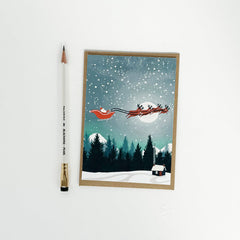 Santa with flying sleigh and reindeer card