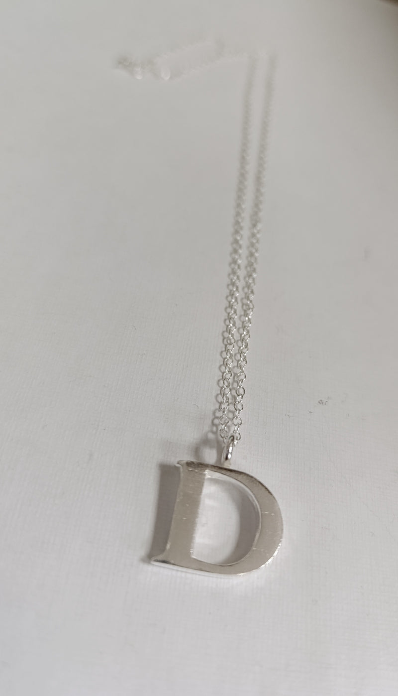 Sterling silver sand cast letter D necklace