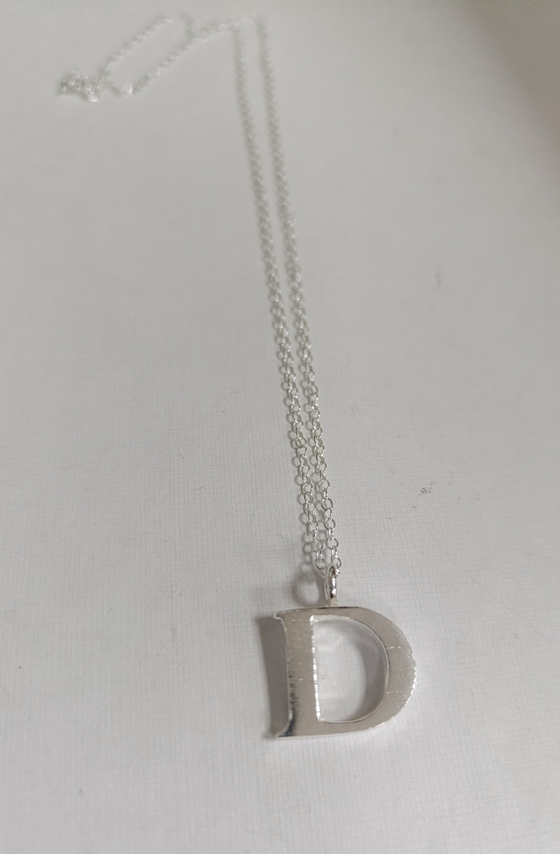 Sterling silver sand cast letter D necklace