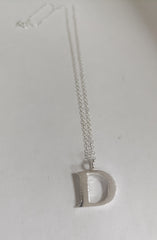 Sterling silver sand cast letter D necklace
