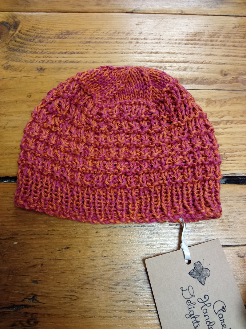 Hand knitted lightweight cotton adult hat in Brick design - pink and orange