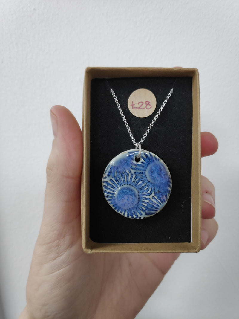 Sun design imprinted blue ceramic necklace