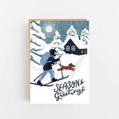 Season's greetings skier, dog and winter cabin card