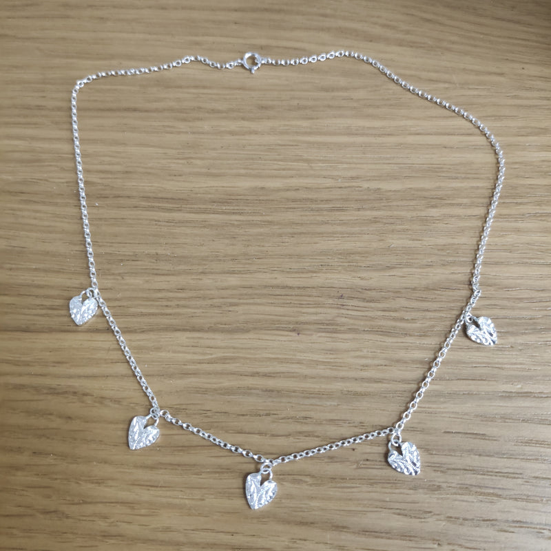 Sterling silver multi textured hearts necklace