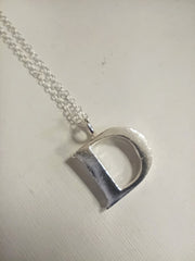 Sterling silver sand cast letter D necklace