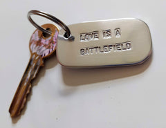 Hand stamped aluminium keyring - Love is a Battlefield