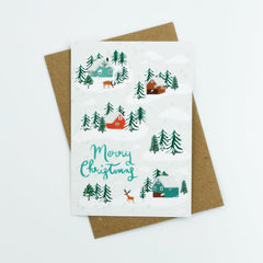 Merry Christmas reindeer and houses in the snow card